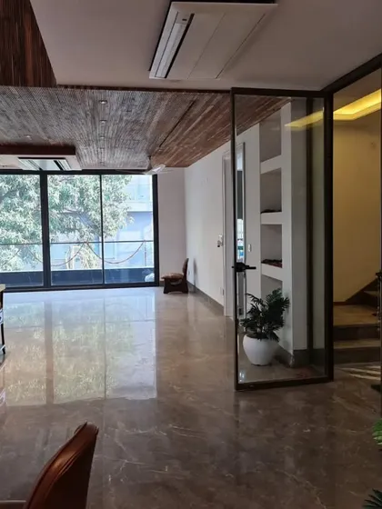 Another view from the site, showing the wooden ceiling detail and glass partitions being installed. This stage is where the architectural bones of our interior design begin to take shape.