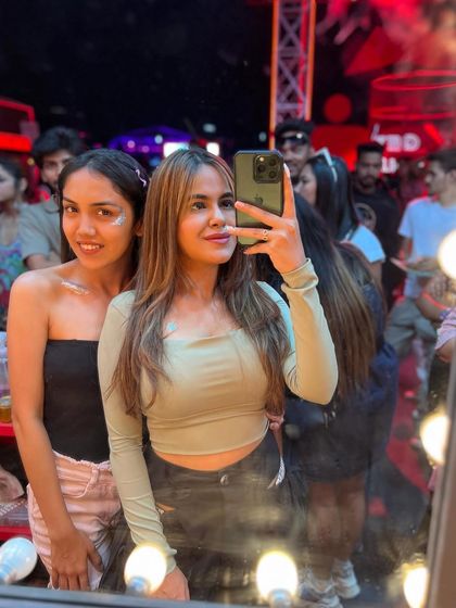 A selfie in the mirror at my glitter bar. It's a fun, interactive space where guests can hang out and get ready together.