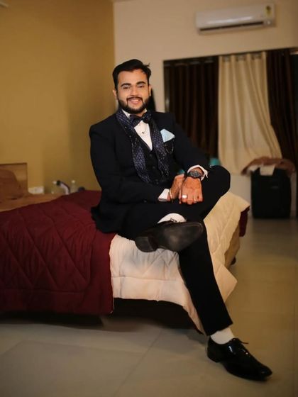 This dark blue suit features a unique computerized hexagon pattern on the waistcoat and tie. It's a subtle way to add a modern twist to a formal wedding suit.