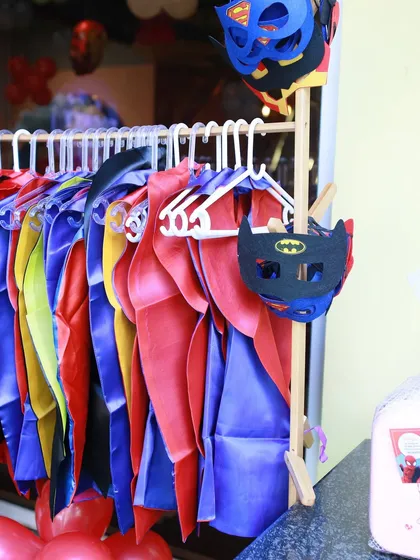 Every hero needs a costume. We provide a rack of colorful capes and masks, featuring characters like Batman and Superman, so each guest can choose their identity and join the adventure.