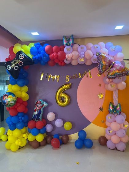 When twins have different favorite things, I create a theme that celebrates both! This 6th birthday party combined the worlds of Super Mario and beautiful butterflies, with a colorful balloon arch connecting both themes for a unique and personalized setup.