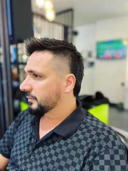 A modern mullet paired with a disconnected goatee and beard. This style is for those who want a unique and edgy look.