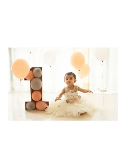 A classic portrait from a first birthday studio session. The clean, bright background and simple props ensure that your little one is the star of the show.