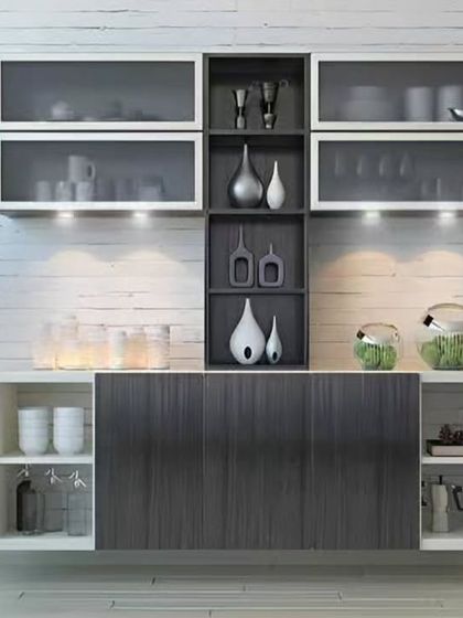 A sleek and modern wall-mounted display unit. The combination of frosted glass cabinets, dark wood shelving, and integrated lighting is perfect for showcasing fine crockery or decor.