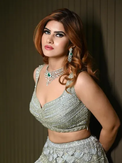 A full portrait of the sangeet glam look. The makeup is designed to complement the intricate details of the outfit while making the bride feel confident and beautiful.