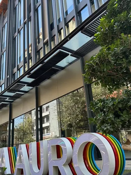 Another view of the Sattva Auro building, highlighting the interaction between the structure and the surrounding landscape. The design ensures the building is both functional and aesthetically integrated into its urban environment.