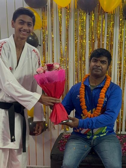 A senior student with a black belt expressing his respect, a core value we teach alongside karate techniques.