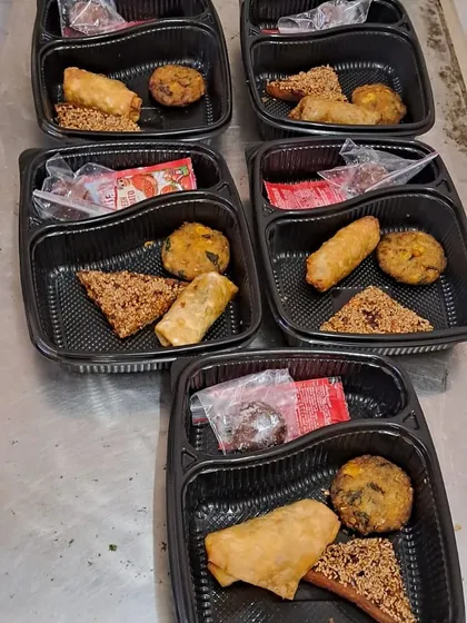 We also provide starters in convenient packed boxes for smaller events or corporate lunches. This box includes a spring roll, a vegetable cutlet, and a savory dhokla-style snack.