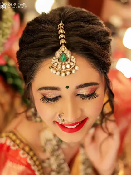 For beauty and makeup portfolios, the details are everything. This is a close-up shot focusing on the bride's radiant smile and the flawless makeup application, from the shimmering eyeshadow to the perfectly defined lips.