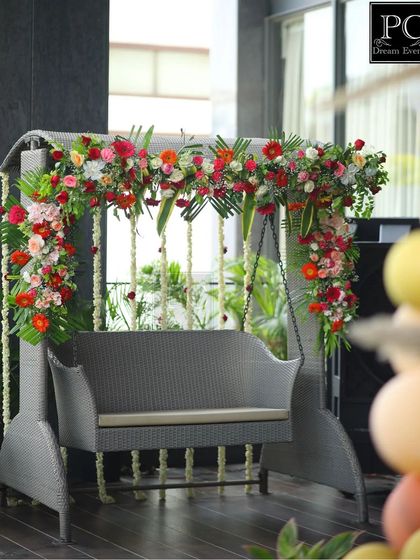 A detail shot of the floral swing decoration. We use a variety of fresh flowers and greenery to create a vibrant and fragrant setting for the guest of honor.
