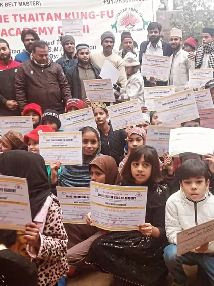 The entire group of students, young and old, showing their certificates of achievement. This is the community we build, where everyone's hard work is recognized.
