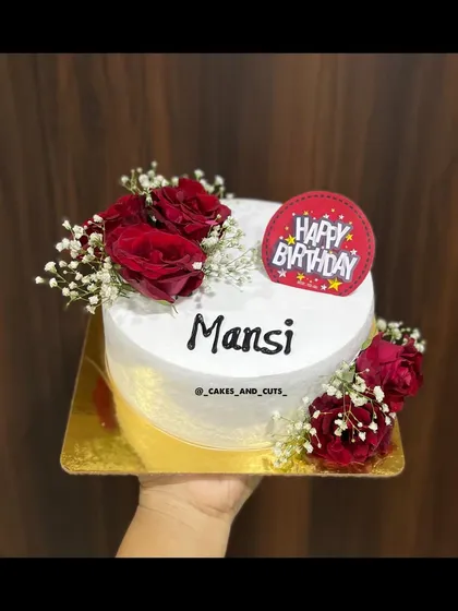 A simple yet beautiful birthday cake decorated with fresh red roses and baby's breath.