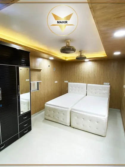 Comfort and style are built into our portable living spaces. This fully furnished bedroom features integrated storage, modern lighting, and two comfortable beds, proving that compact living doesn't mean compromising on luxury.