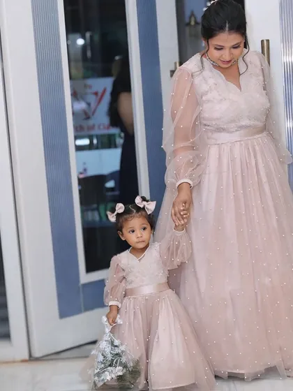 Create precious memories with my custom mom-daughter twinning outfits. This matching set of pearl-studded pink gowns is perfect for birthdays, parties, or any event where you want to share a special style moment with your little one.