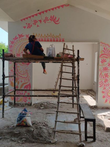 Taking a moment to plan my next move on the 'Baba's Garden' mural. Each section is sketched out in my mind before I apply the paint, allowing the design to flow organically across the walls.