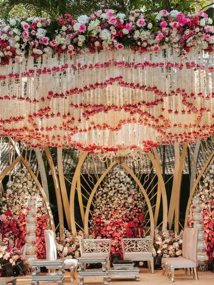 The Lotus Mandap stage set for the ceremony. The design combines a traditional floral canopy with a modern, sculptural frame, creating a unique and memorable structure.