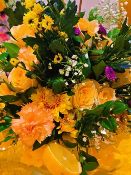 A beautiful bouquet of yellow roses, carnations, and daisies, perfectly capturing the sunny and cheerful spirit of a Haldi ceremony.