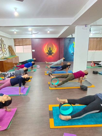 Our class uses yoga wheels to practice a variation of plank pose. This adds a core stability challenge and helps to strengthen the entire body.