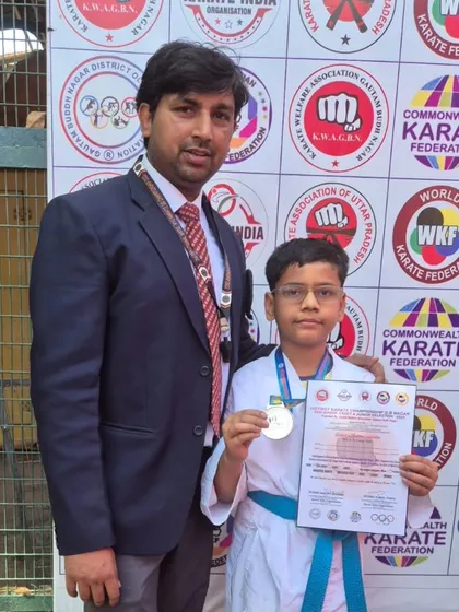 This young student earned his silver medal in kumite at the district championship, a crucial step towards bigger tournaments.