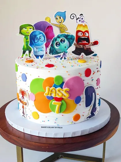 A cake full of feelings! This vibrant Inside Out themed cake for a seventh birthday is decorated with all the beloved characters, colorful memory orbs, and rainbow sprinkles for a truly joyful celebration.