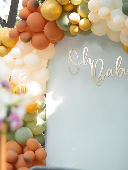 The elegant script and soft colors of this baby shower backdrop create a sophisticated and sweet atmosphere for welcoming a new arrival.