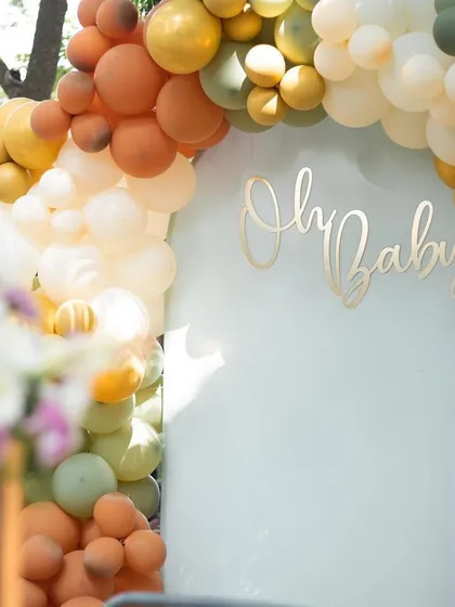 The elegant script and soft colors of this baby shower backdrop create a sophisticated and sweet atmosphere for welcoming a new arrival.