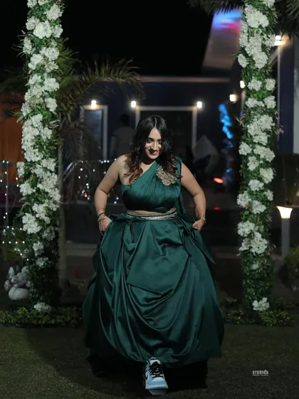 A fun twist, pairing the elegant green gown with sneakers. This shows my personality and how I can style high-fashion pieces in a unique, relatable way.
