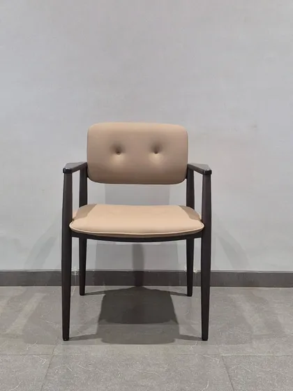 A classic wooden dining chair with a button-tufted backrest. This timeless design is sturdy and comfortable, suitable for any home.