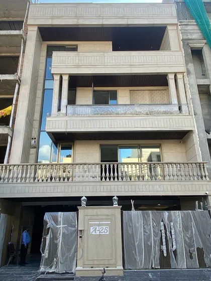 The real-world construction of a neoclassical home, based on our 3D model in image 8. This photo, taken during the final stages, shows the stone cladding, classical columns, and balcony balustrades installed exactly as envisioned in the digital design.