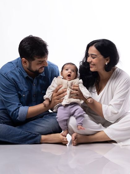 This studio portrait shows us as new parents with a tiny newborn Gauri. It's a beautiful, clean shot that marks the beginning of our journey as a family of three.