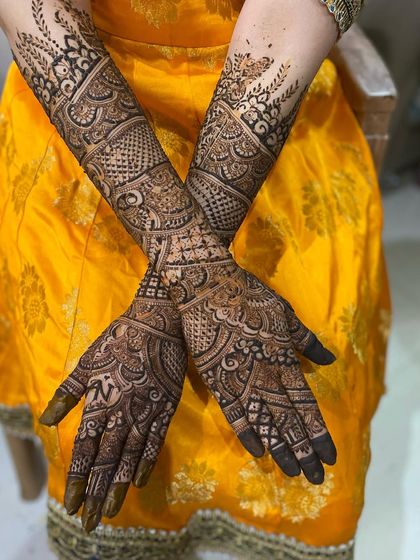 The back of the hands, adorned with intricate patterns that complement the front. This design features a mix of checks, florals, and leafy vines.