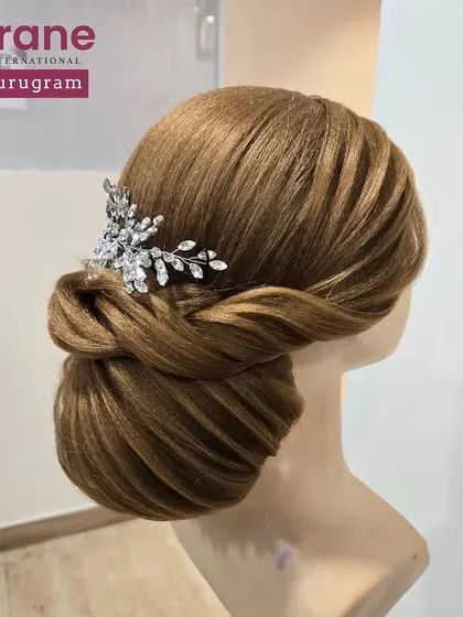 A classic and elegant low bun hairstyle, perfect for a bride or for a formal event. I teach my students to create clean, polished updos that are both beautiful and secure.