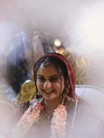 A candid shot of a smiling bride with a soft, textured updo. This style is perfect for a bride who wants a more relaxed yet elegant look for her wedding day.