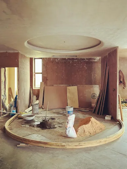 A circular motif defines the layout of this small office. Even in its raw construction phase, the geometry of the space is clear.