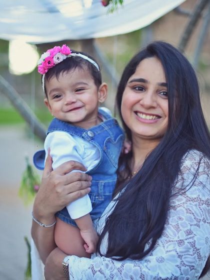 A sweet mother and daughter moment captured during an outdoor session. The beautiful natural light and her baby's happy smile make this a truly heartwarming portrait.