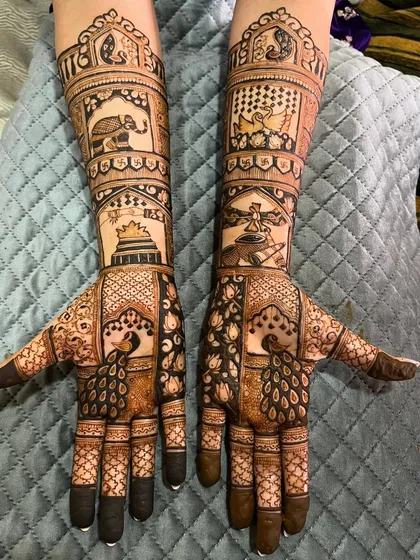 This bridal design is filled with a variety of elements, including elephants, temples, and peacocks. It's a beautiful tapestry of traditional Indian motifs.