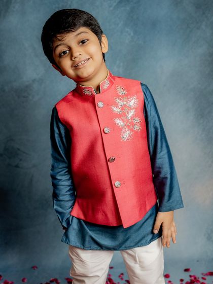 Carefully designed and exquisitely detailed. This vibrant red Bundi with delicate silver lotus embroidery is the ultimate choice for a festive occasion, offering style that is built to last.