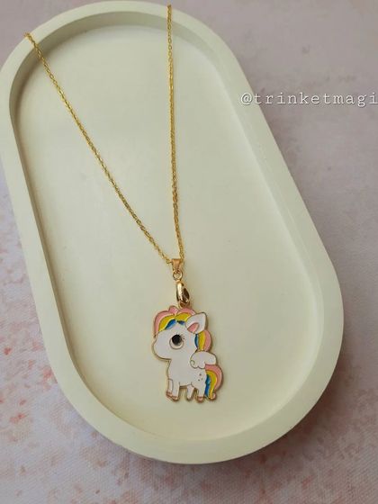 Another magical unicorn necklace, this one featuring a unicorn with rainbow hair. It's a colorful and fun accessory for any child.