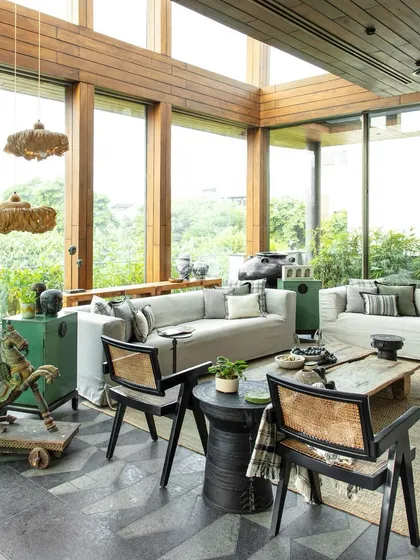 The sun-drenched conservatory at the Bammi Residence, featured in Living Etc. India. This space is a perfect example of our Wabi-Sabi inspired design, blending rustic furniture with modern architectural lines.