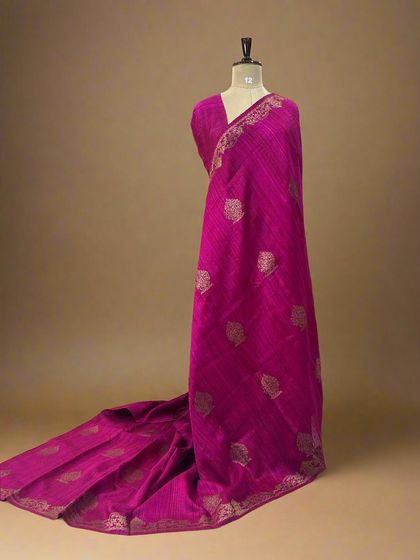 A vibrant rani pink pure Dupion Banarasi silk saree with a delicate checks pattern and leaf butis.
