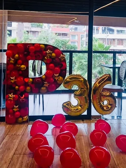 Custom mosaic letters are a great way to personalize an event. This large 'P' filled with red and gold balloons was created for a 36th birthday celebration.