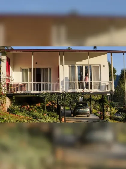 This angle shows how the upper level of the farmhouse is supported, creating a covered parking space below while maximizing the living area's connection to the view. It's a functional solution that adds to the building's light, elevated feel.