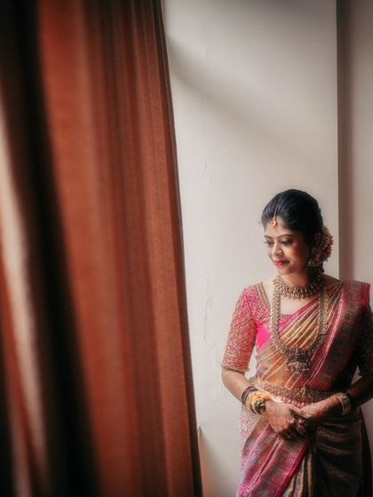 A contemplative bridal portrait, using window light to create a soft and moody atmosphere.
