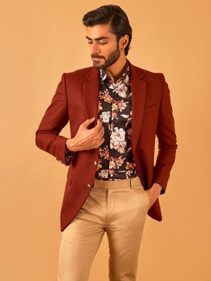 A rich maroon blazer paired with a floral shirt and khaki trousers. This look shows how to expertly layer colors and patterns for a sophisticated yet approachable style.