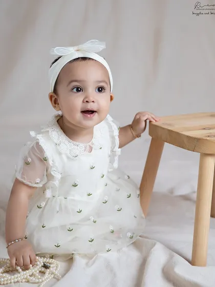 Dressed in a beautiful embroidered dress, this baby girl is all smiles. I love helping families choose outfits that complement the style of the shoot.