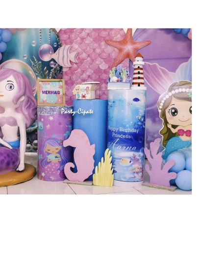 A collection of props used in the mermaid party, including a large mermaid figure, a seahorse, and custom-printed plinths.