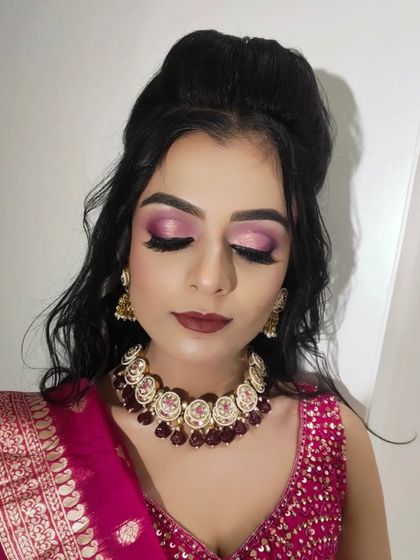 This image captures the full detail of the glittery pink eyeshadow and long lashes.