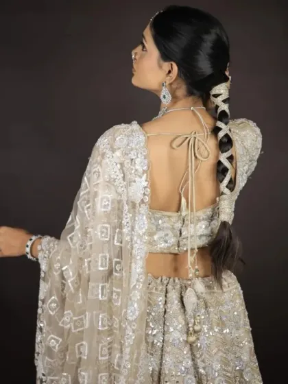 A view of the back of the blouse and the beautiful braided hairstyle. The tie-up detail on the blouse is a lovely touch.