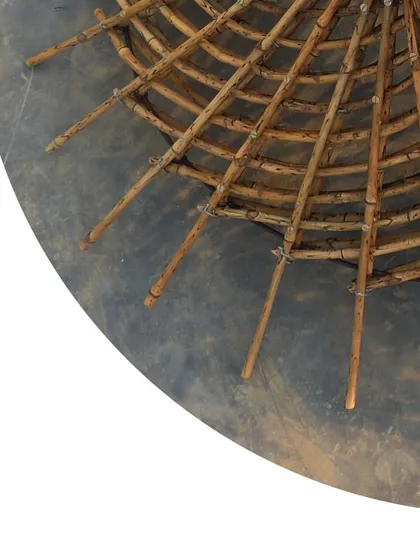 A close-up view of the maquette, detailing how the smaller bamboo pieces are woven and tied together to form the structural web.