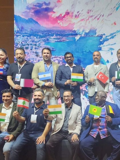 Country representatives holding their flags at the FUE Global meeting in Cyprus, showcasing our truly international community.